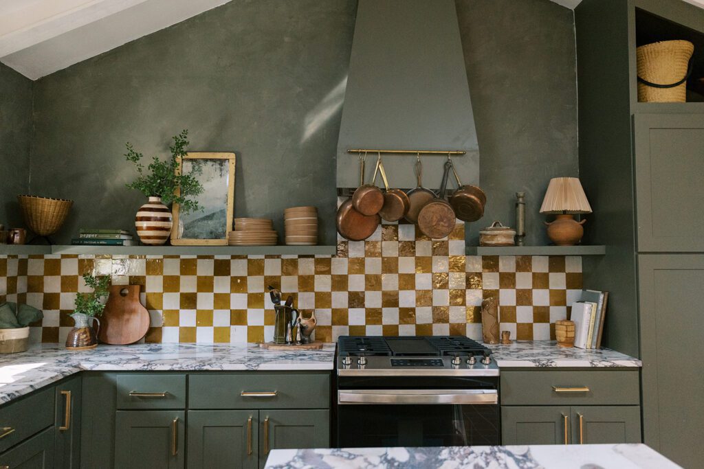 designer mid-century kitchen with green cabinets and checkerboard backsplash