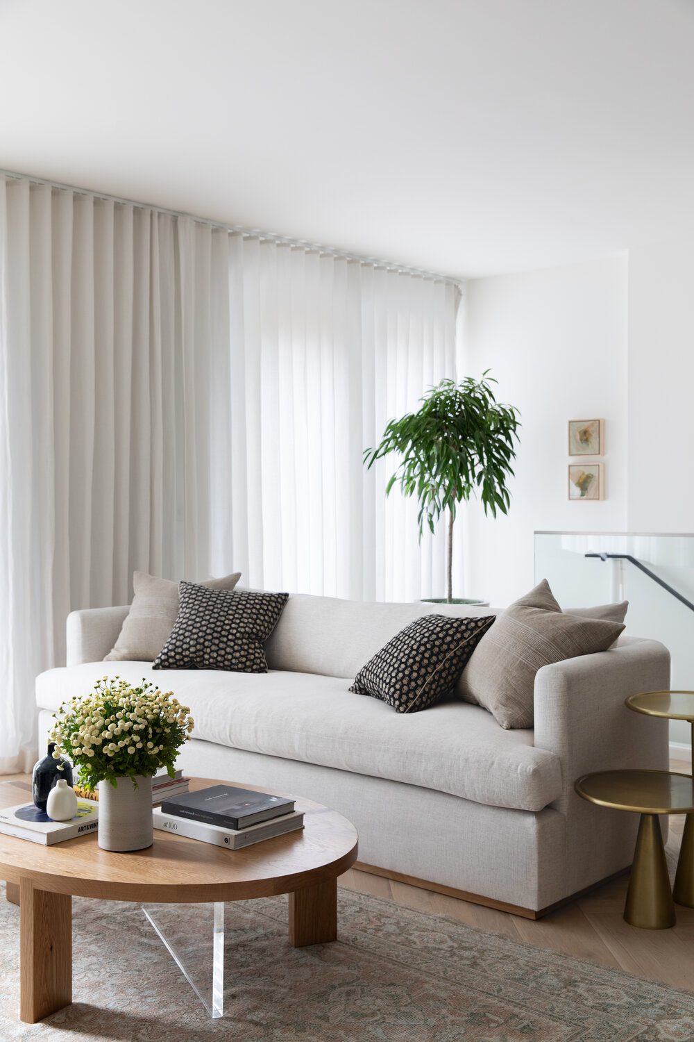 Neutral white living room with floor to ceiling curtains