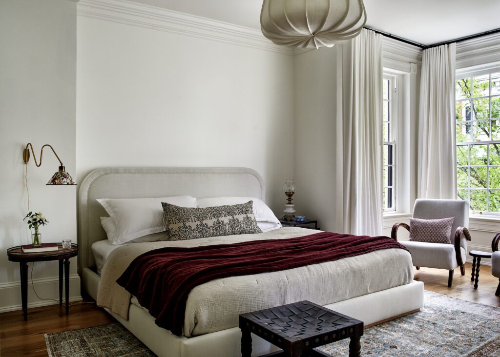 neutral designer home tour bedroom with upholstered bed