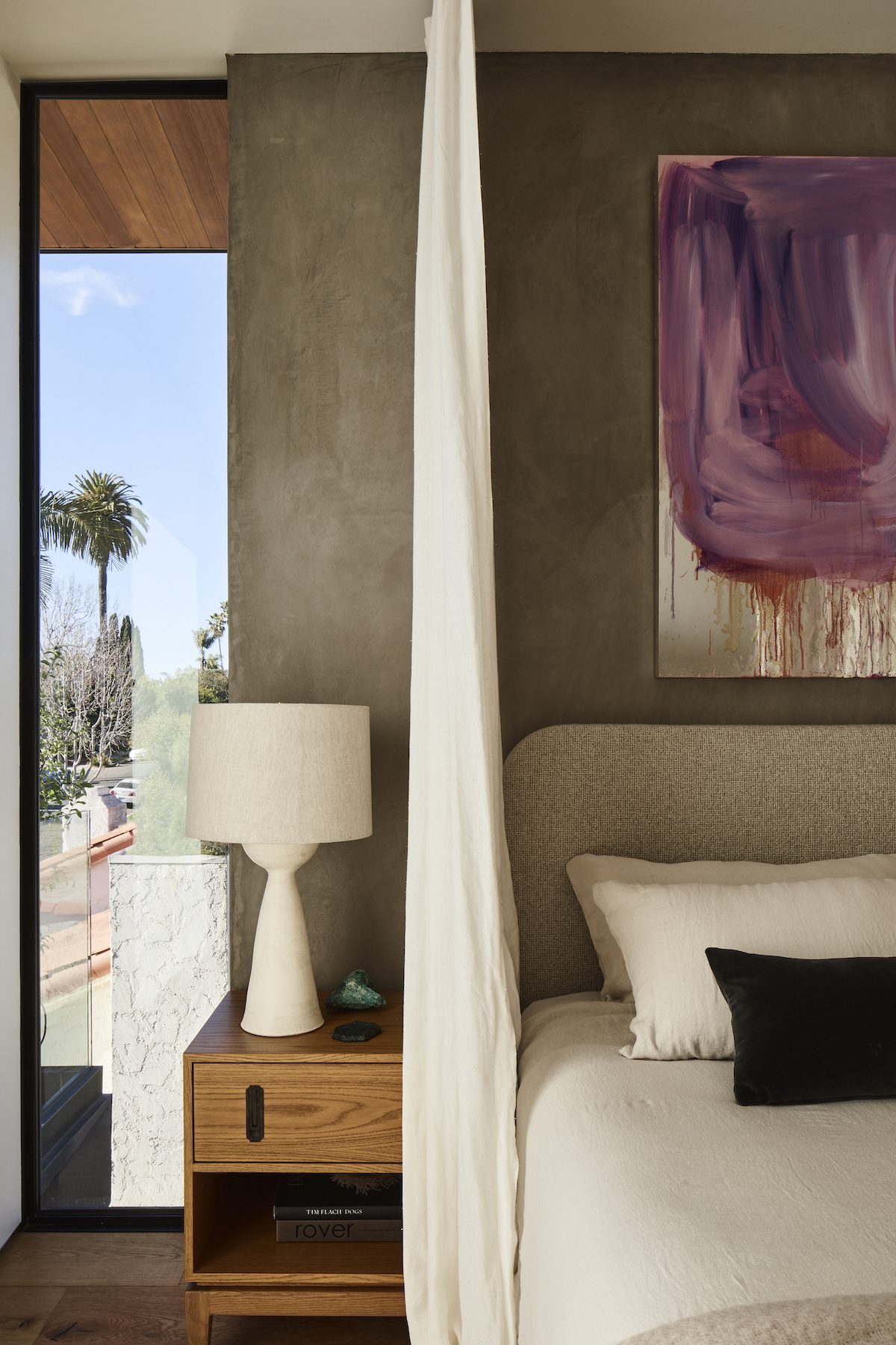 celebrity designer bedroom with purple art and art deco furniture