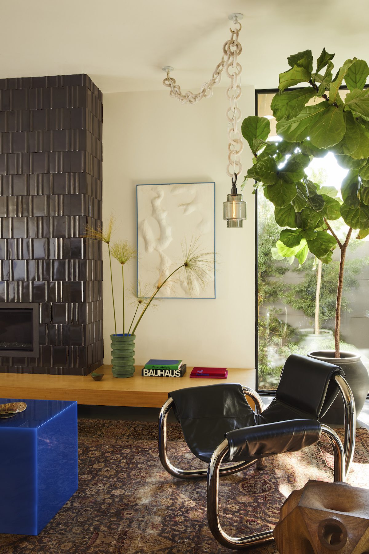 edgy art deco living room with black tile fireplace