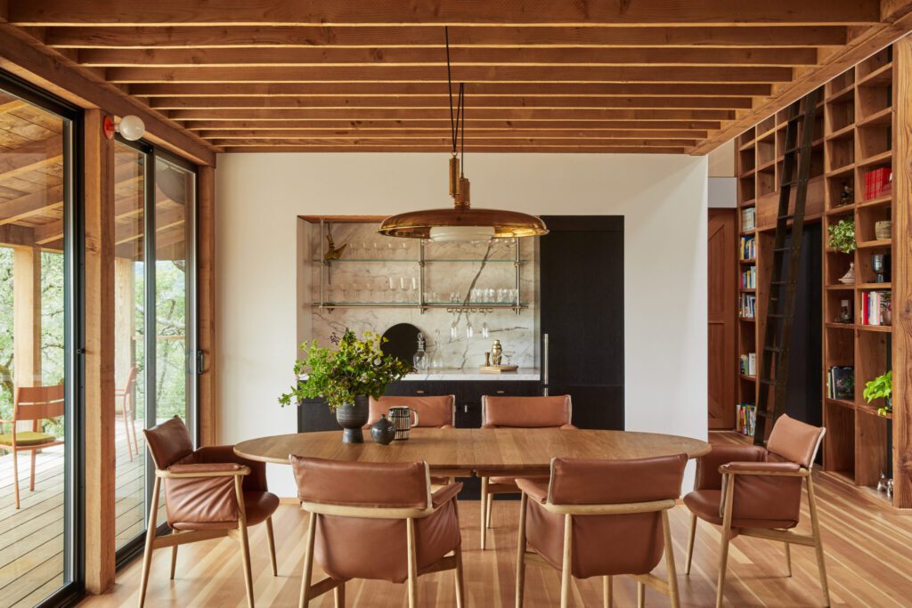 Warm modern mountain dining room with wood ceiling