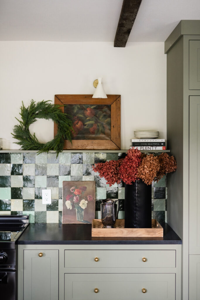 kitchen holiday decor ideas with cypress wreath and florals in red and orange tones