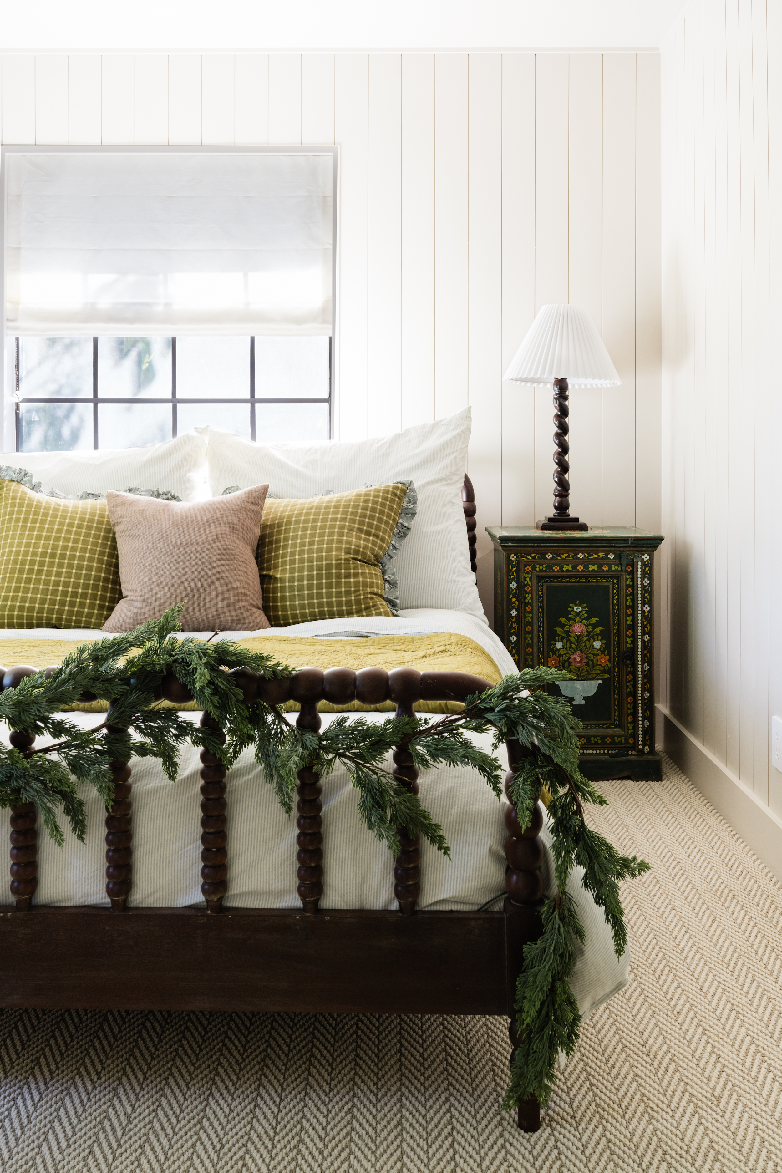 cypress garland decorating the footboard of a spindle bed bedroom holiday decor ideas