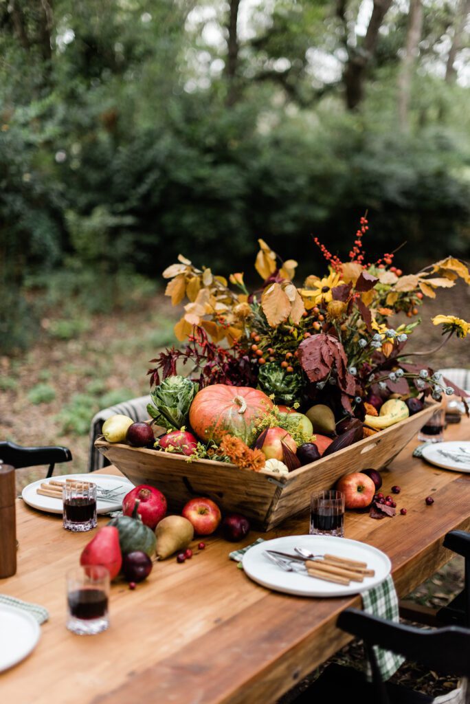 fall foliage, fruit and vegatable centerpiece in an antique dough bowl