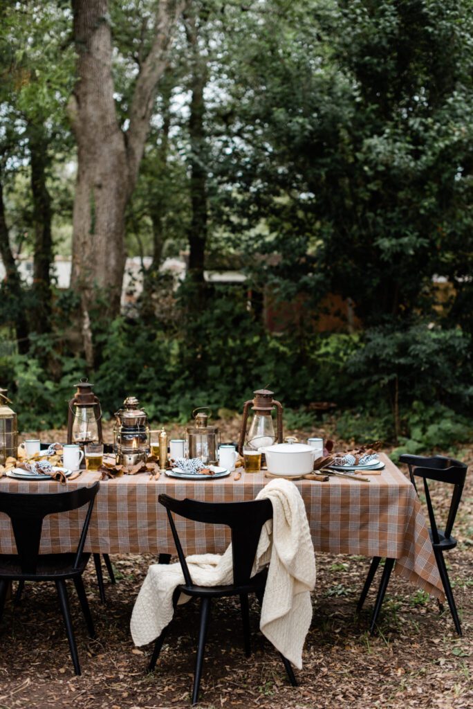 outdoor Thanksgiving table design with plaids and rust, neutral color palette