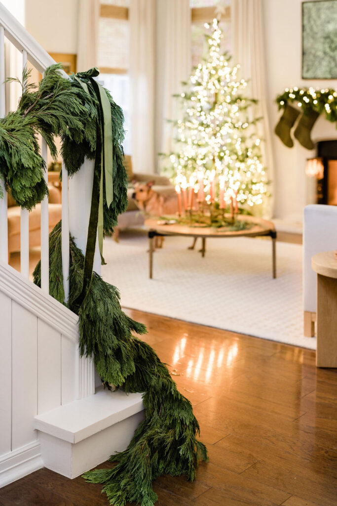 Cypress garland on staircase banister, holiday home decor