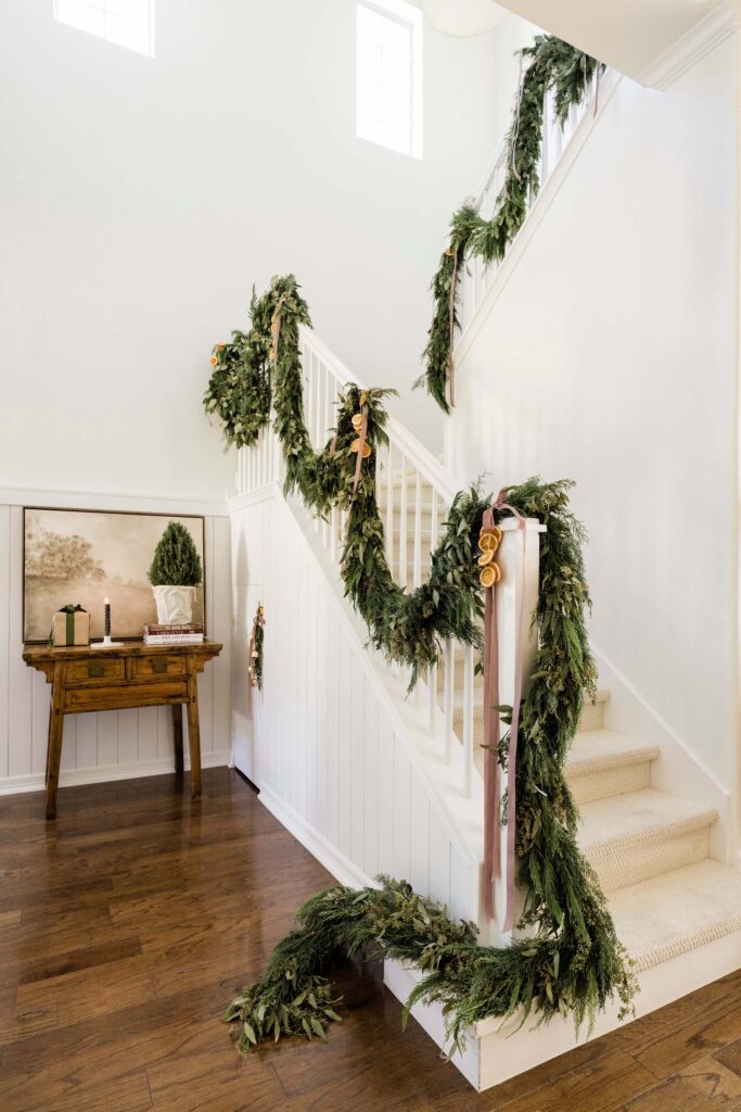 Fresh garland with ribbon down the staircase, holiday home tour