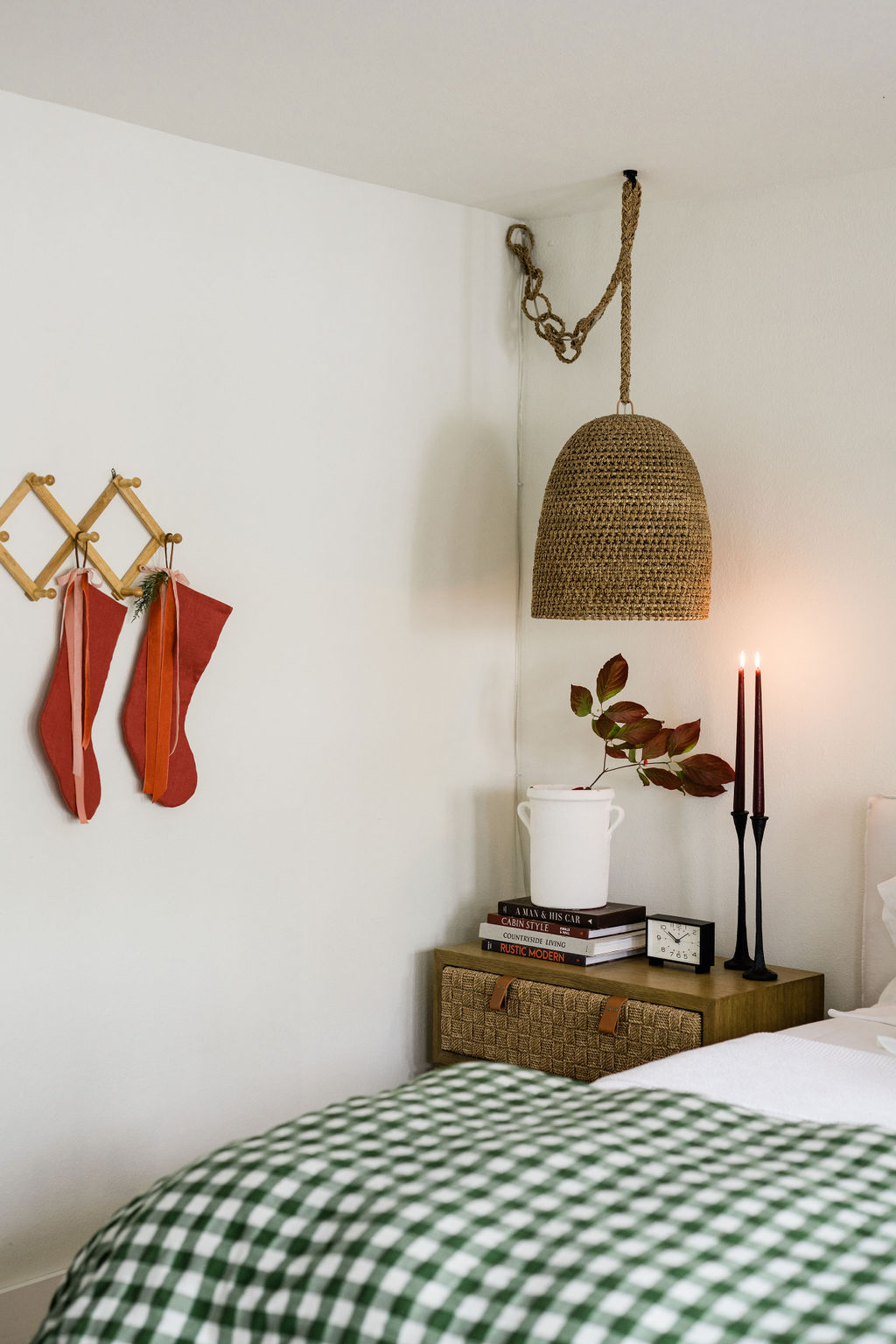 holiday bedroom styling with red stockings and candlelight