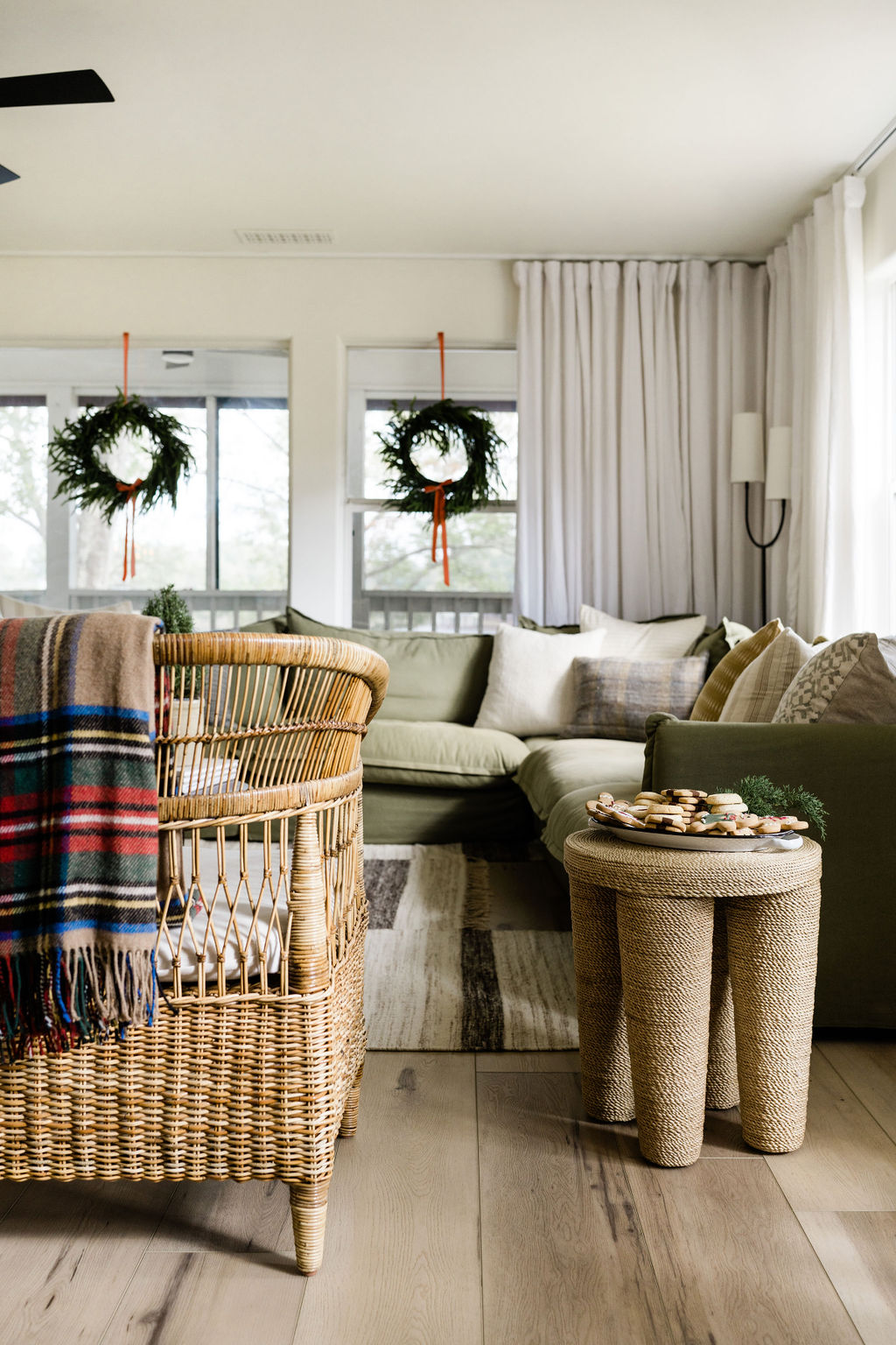 textural woven chair and stool with holiday plaid blanket decorating accents