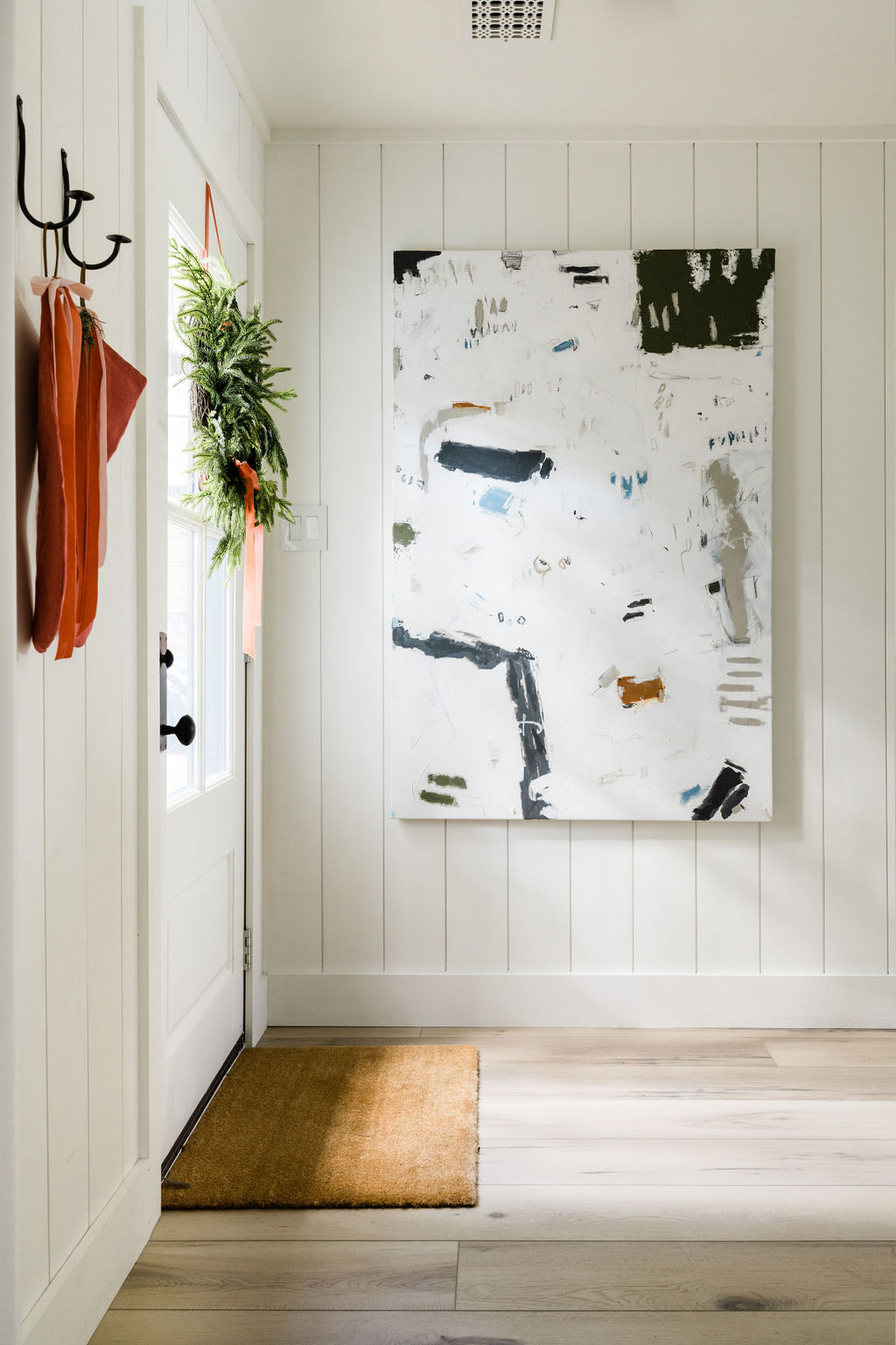 oversized modern art with rustic wood paneling entryway decor