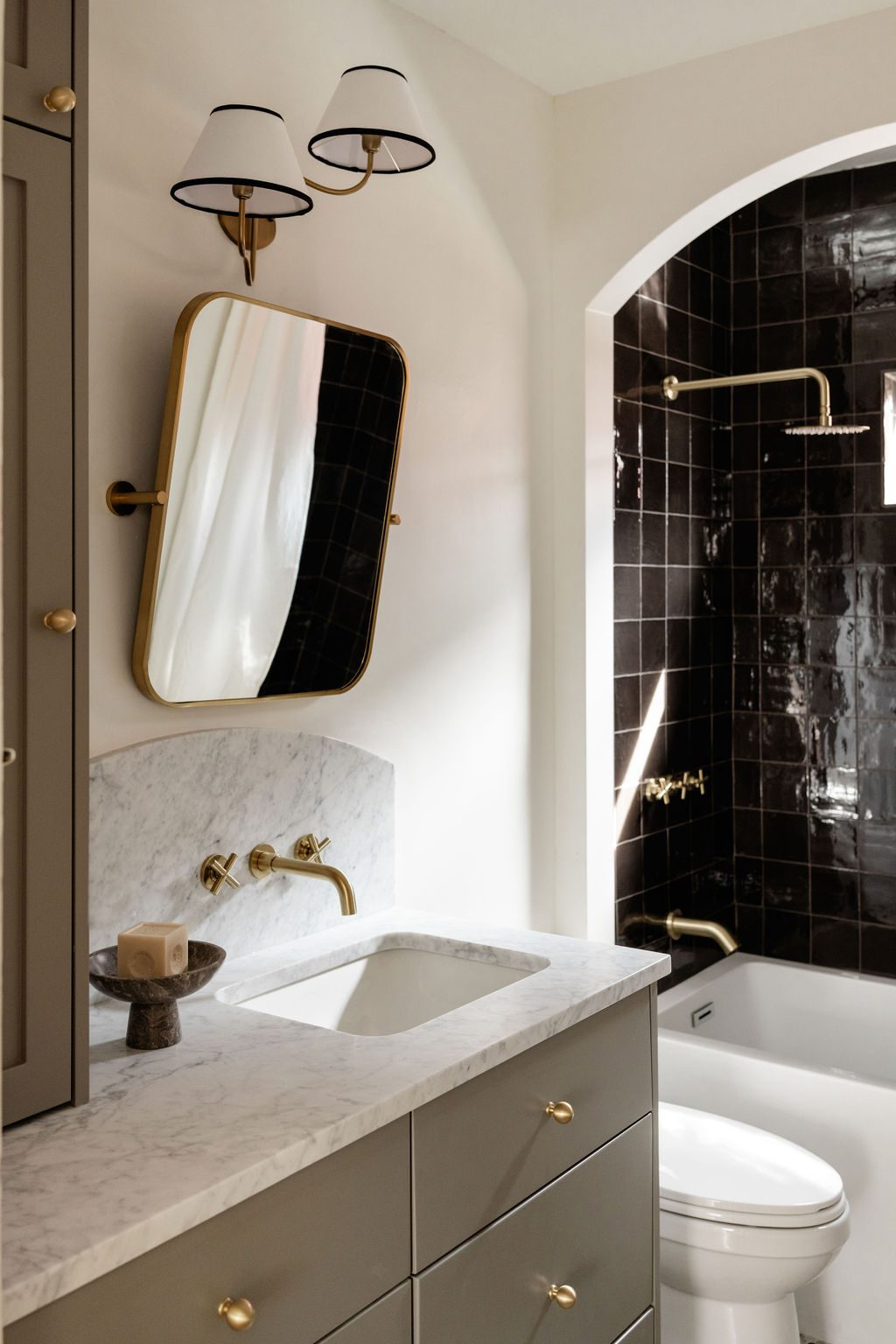 White Vanity And Black Tiled Shower