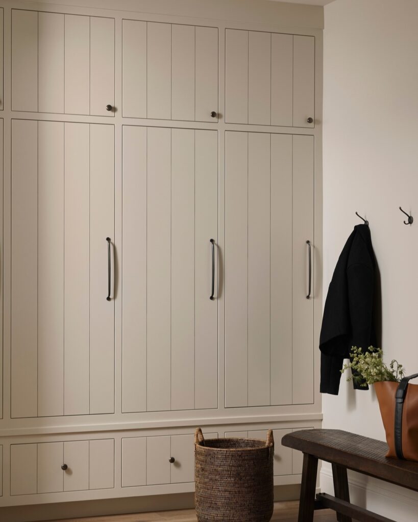 Mudroom design with mushroom colored custom cabinetry