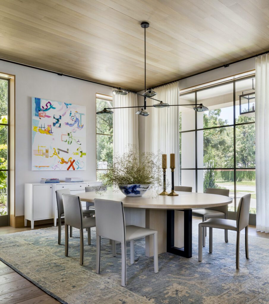 Modern organic dining room with clean lighting lines and a round table