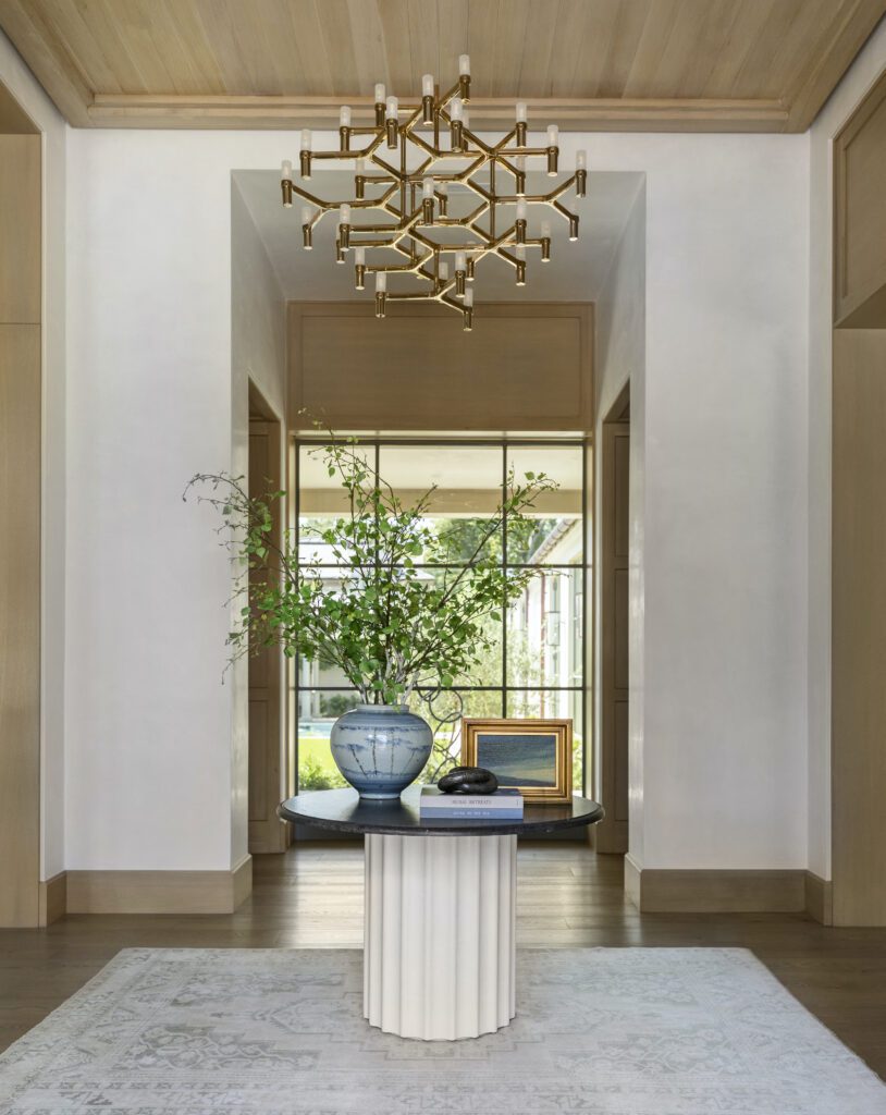 Understated luxury entryway with statement chandelier 