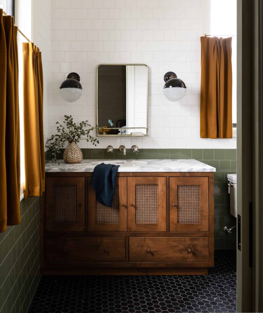 Jewel tone bathroom with mustard curtains and green wall tile