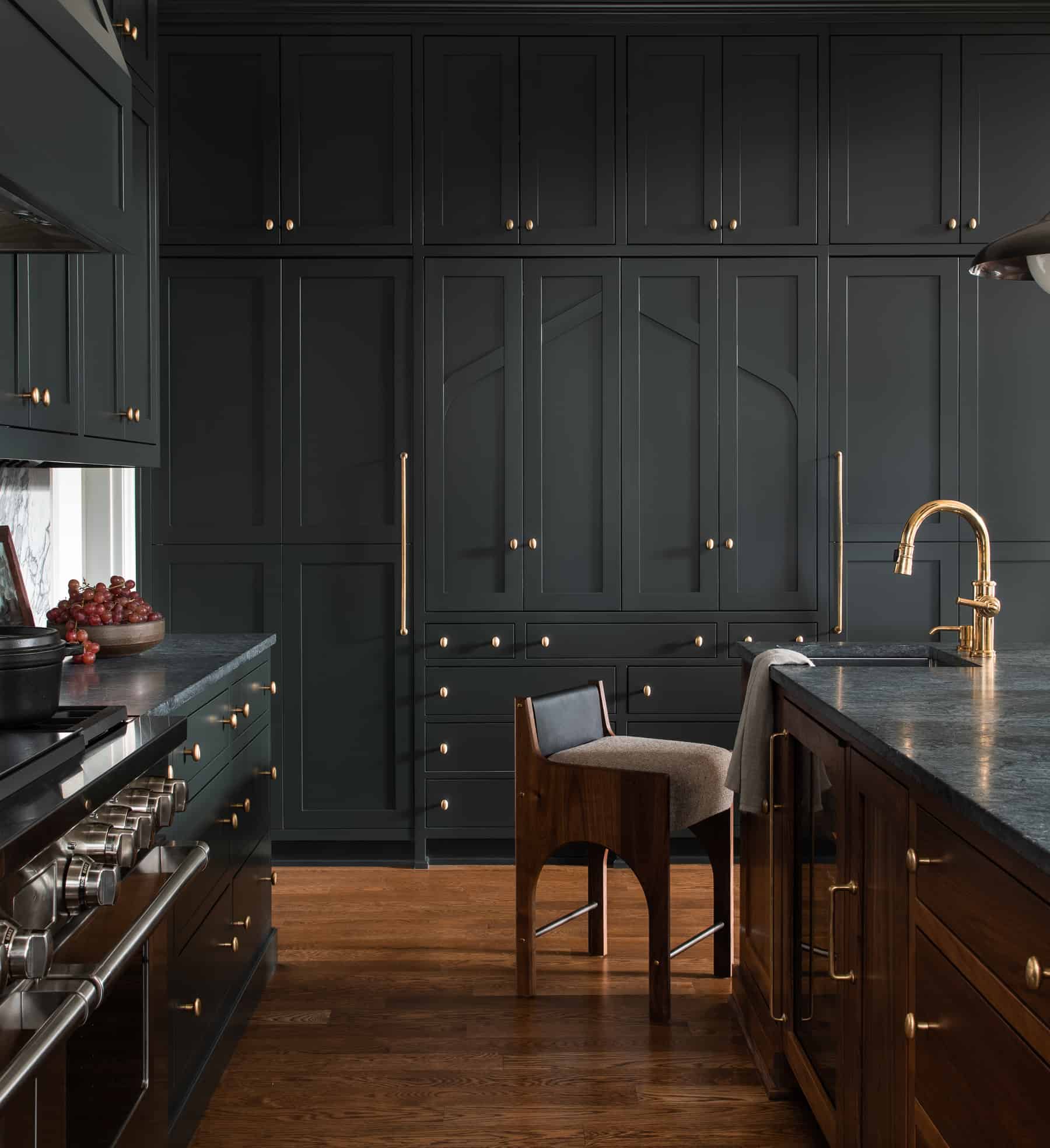 Black kitchen cabinets with brass hardware for a rich drama