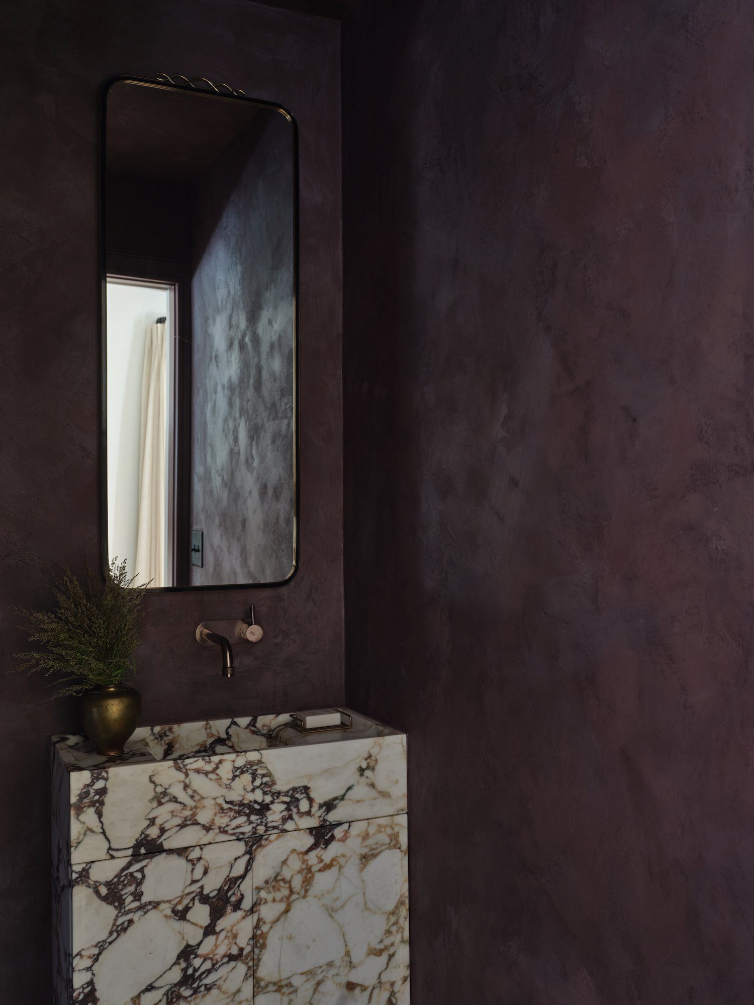 Plum paint color in a powder room with textured walls