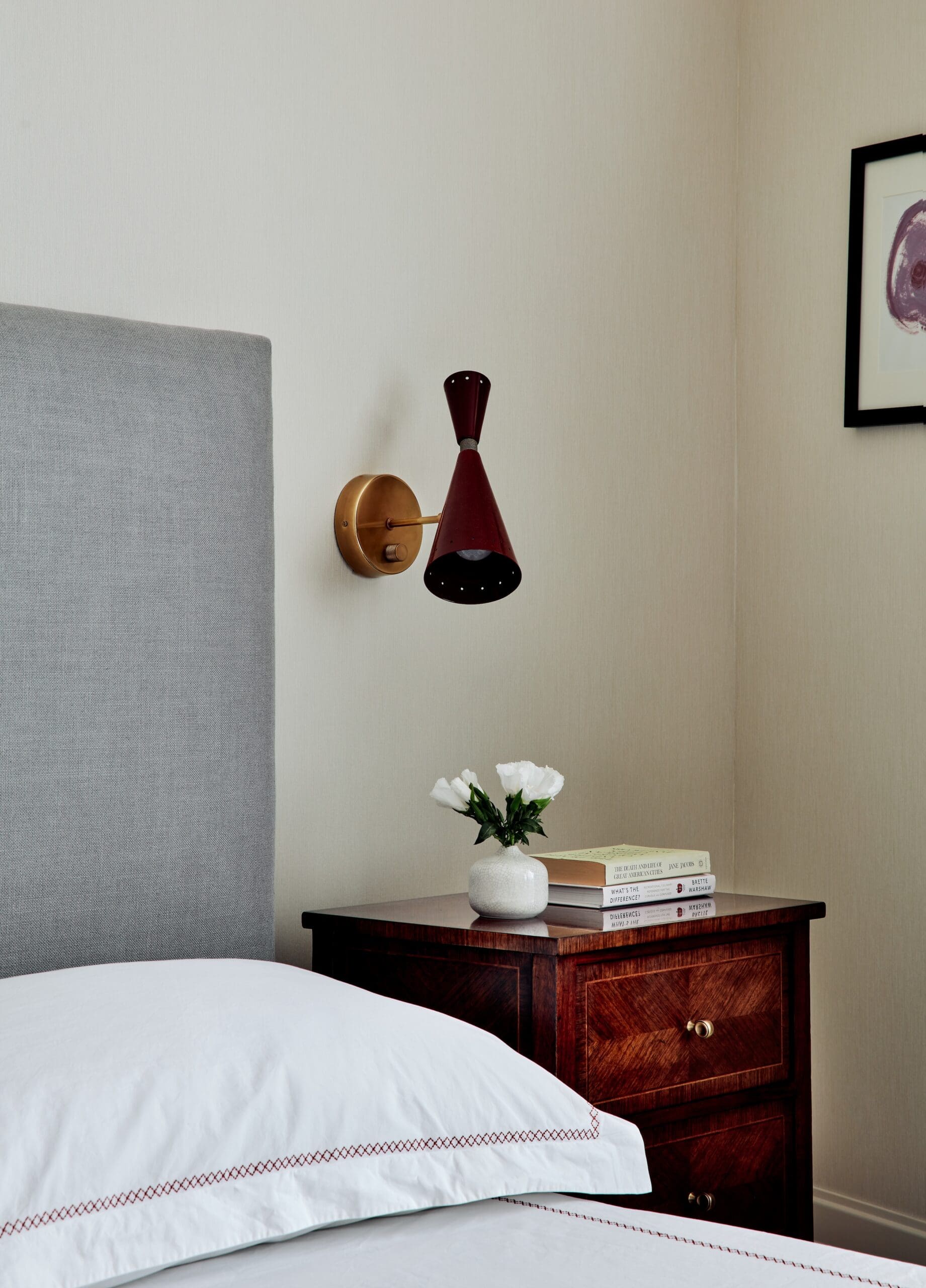 Vintage modern bedroom with a custom red bench in a Brooklyn apartment designed by Julia Baum