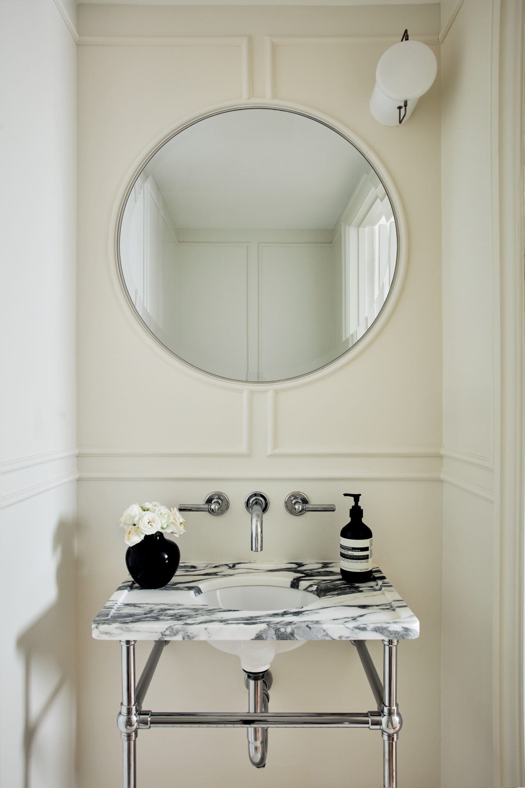 Small powder bath in a Brooklyn apartment with marble sink