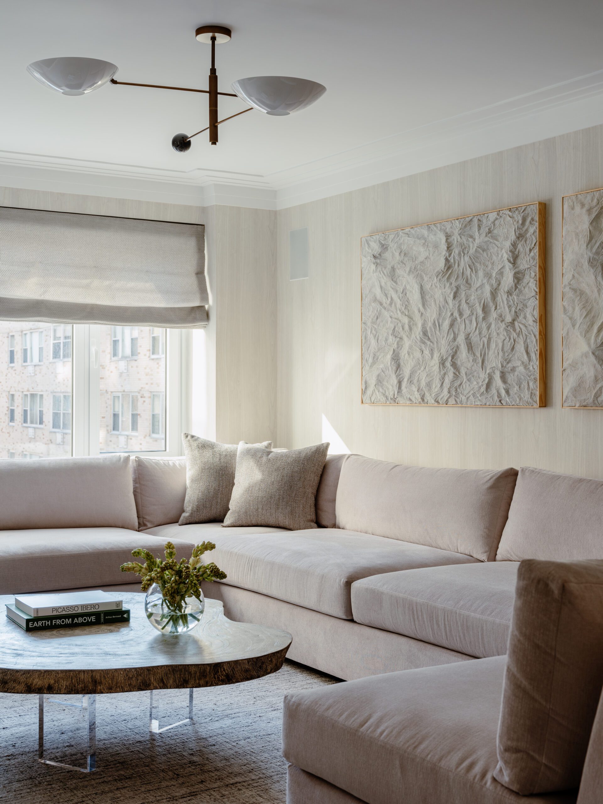 Wallpapered walls with cream sofa and textured artwork