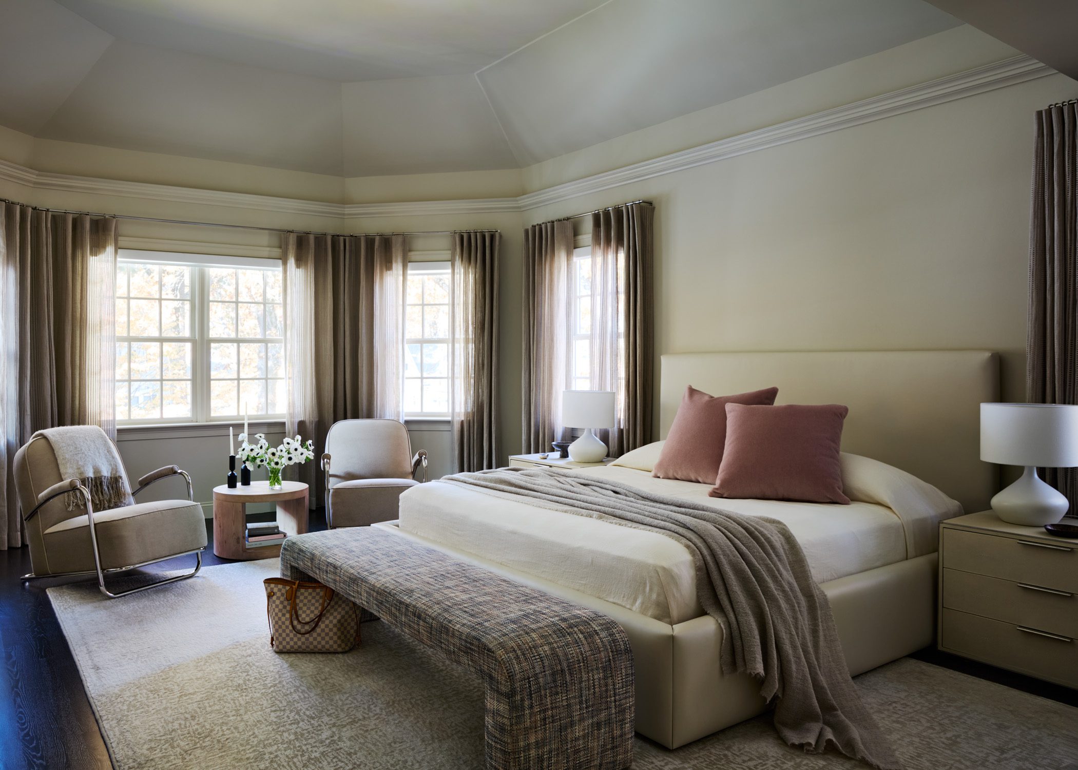 Primary bedroom with soft pink and layered drapery