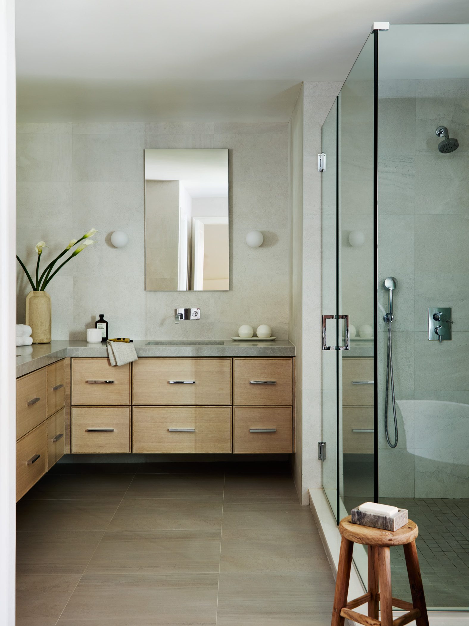 Primary bathroom shower and oak vanity