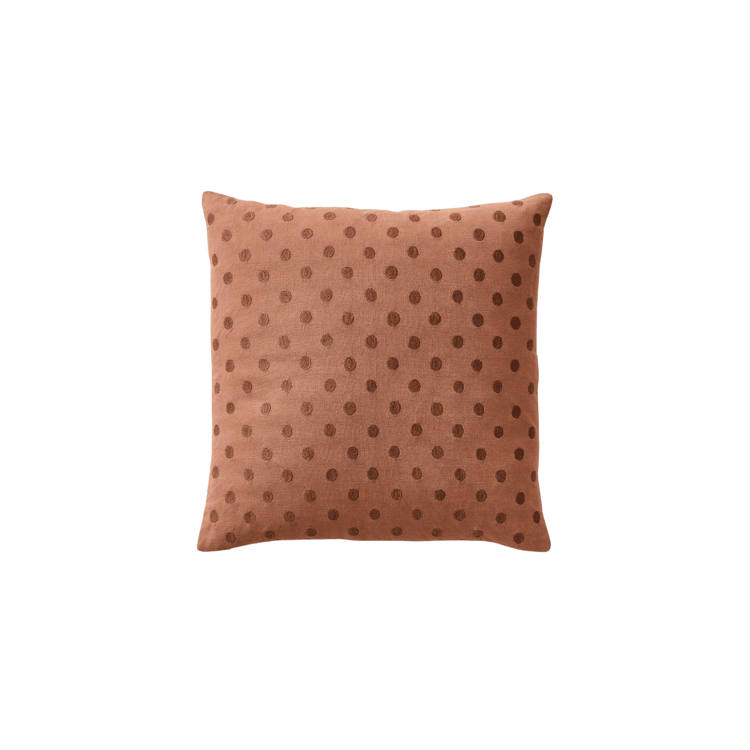 Terracotta colored pillow with dots