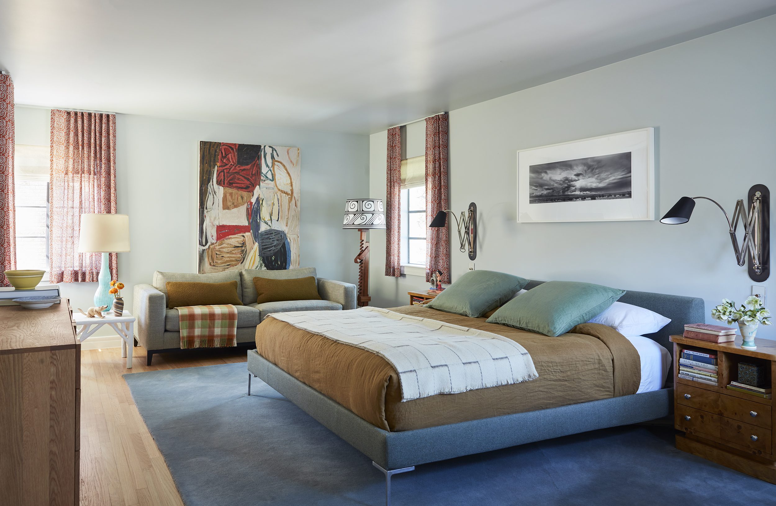Bedroom with blue rug and olive accents