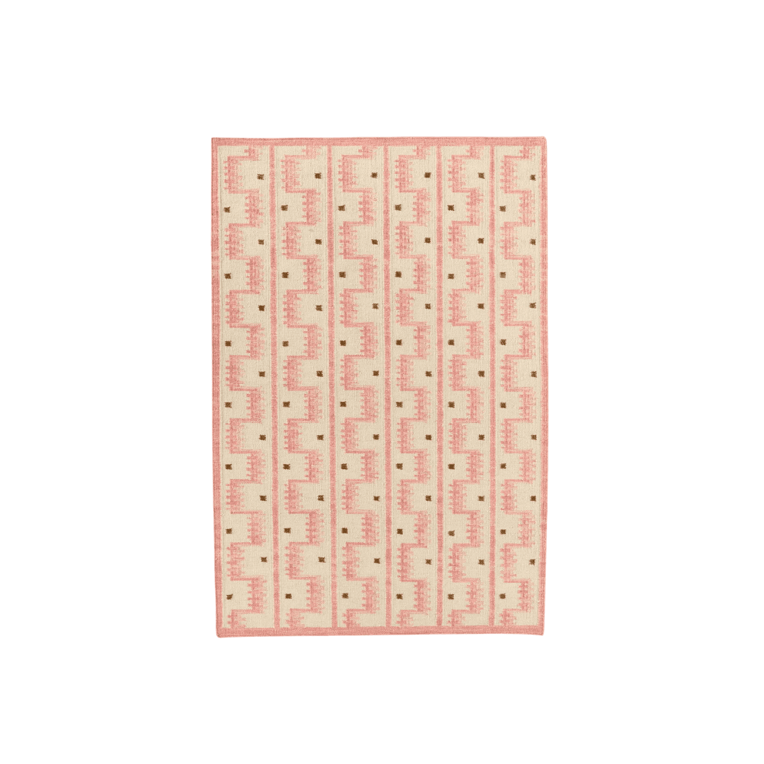 Pink hand woven rug with geometric detail