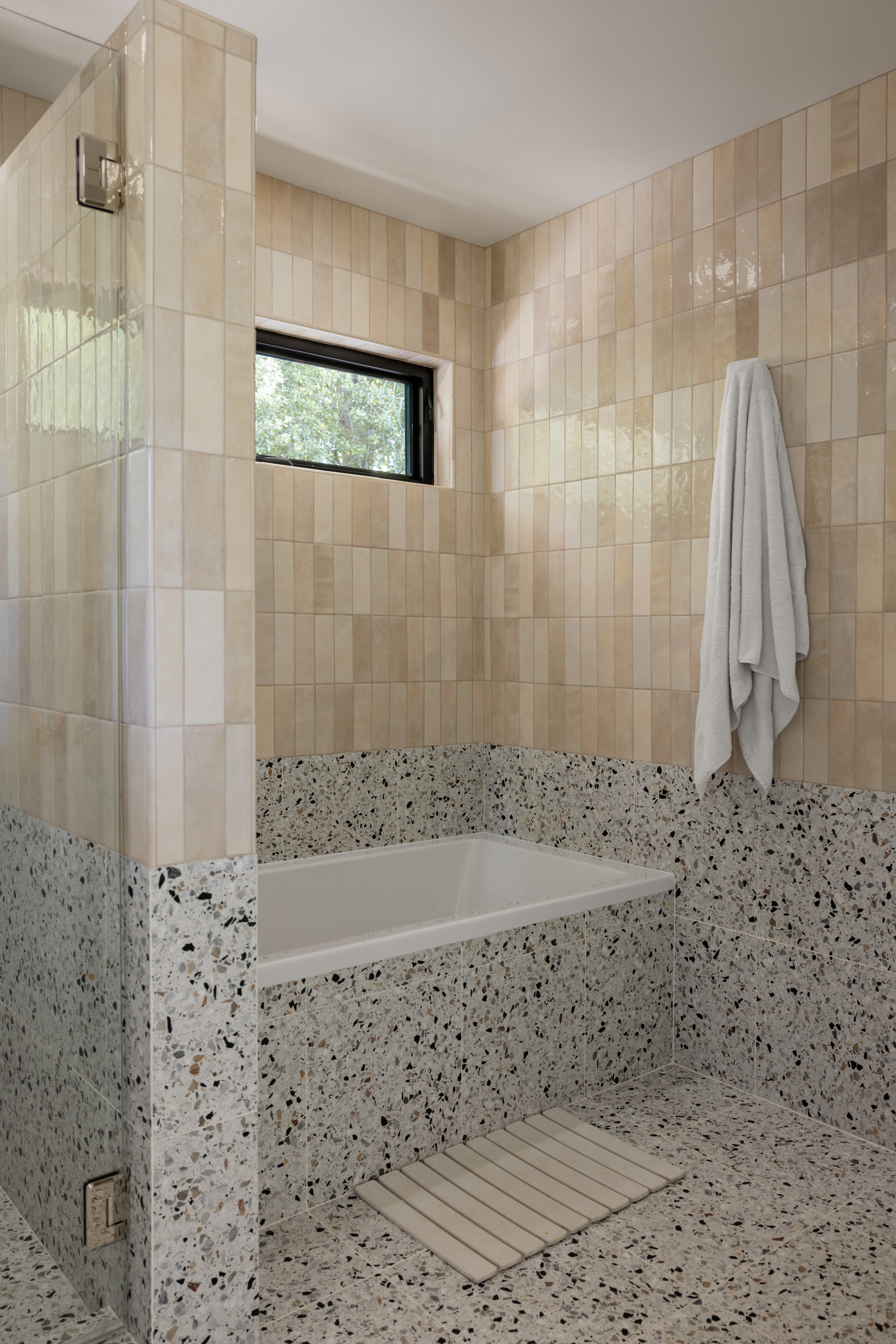 Speckled Stone Flooring and Bathtub Walls