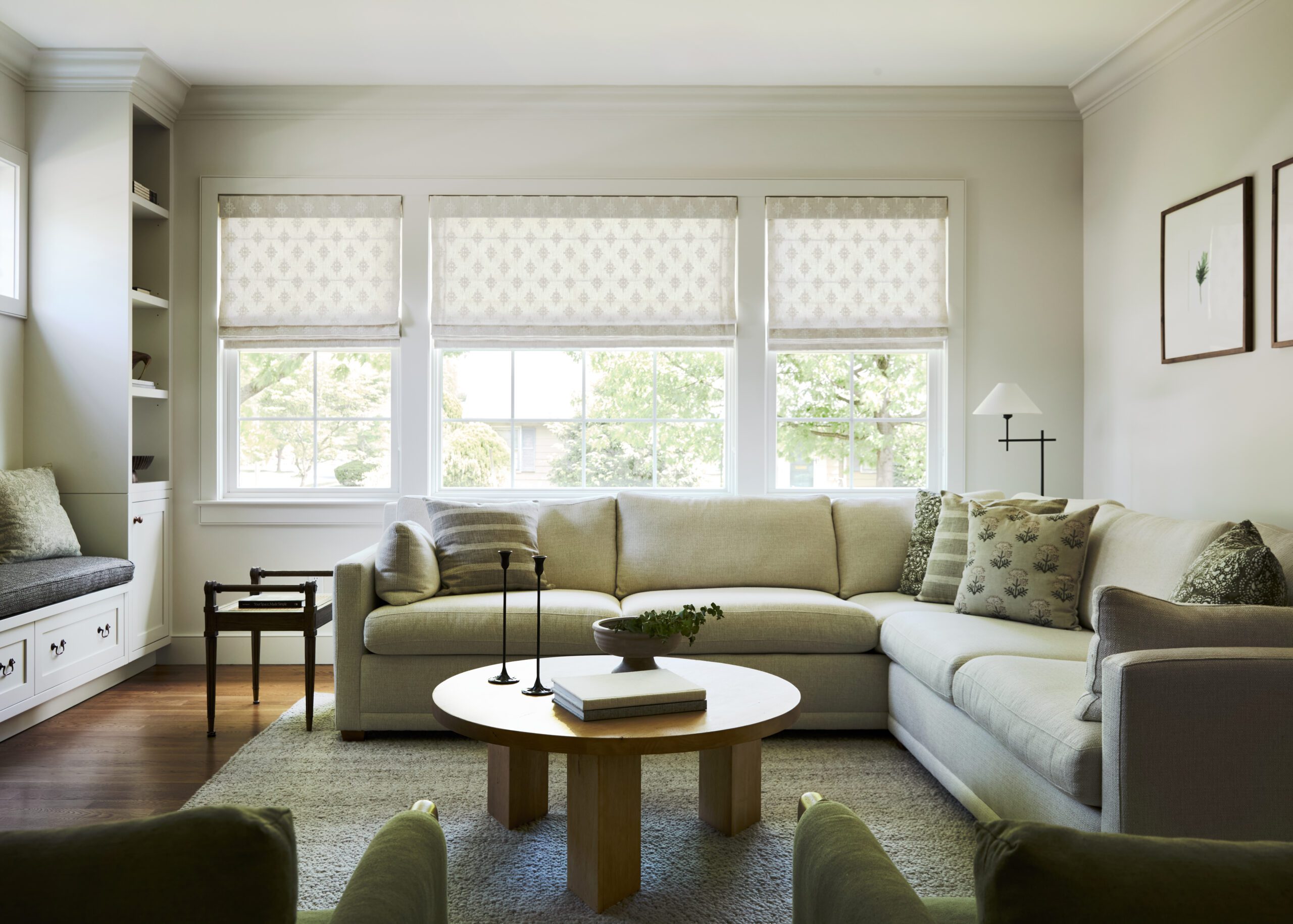 Modern transitional living room white sectional roman shades on windows
