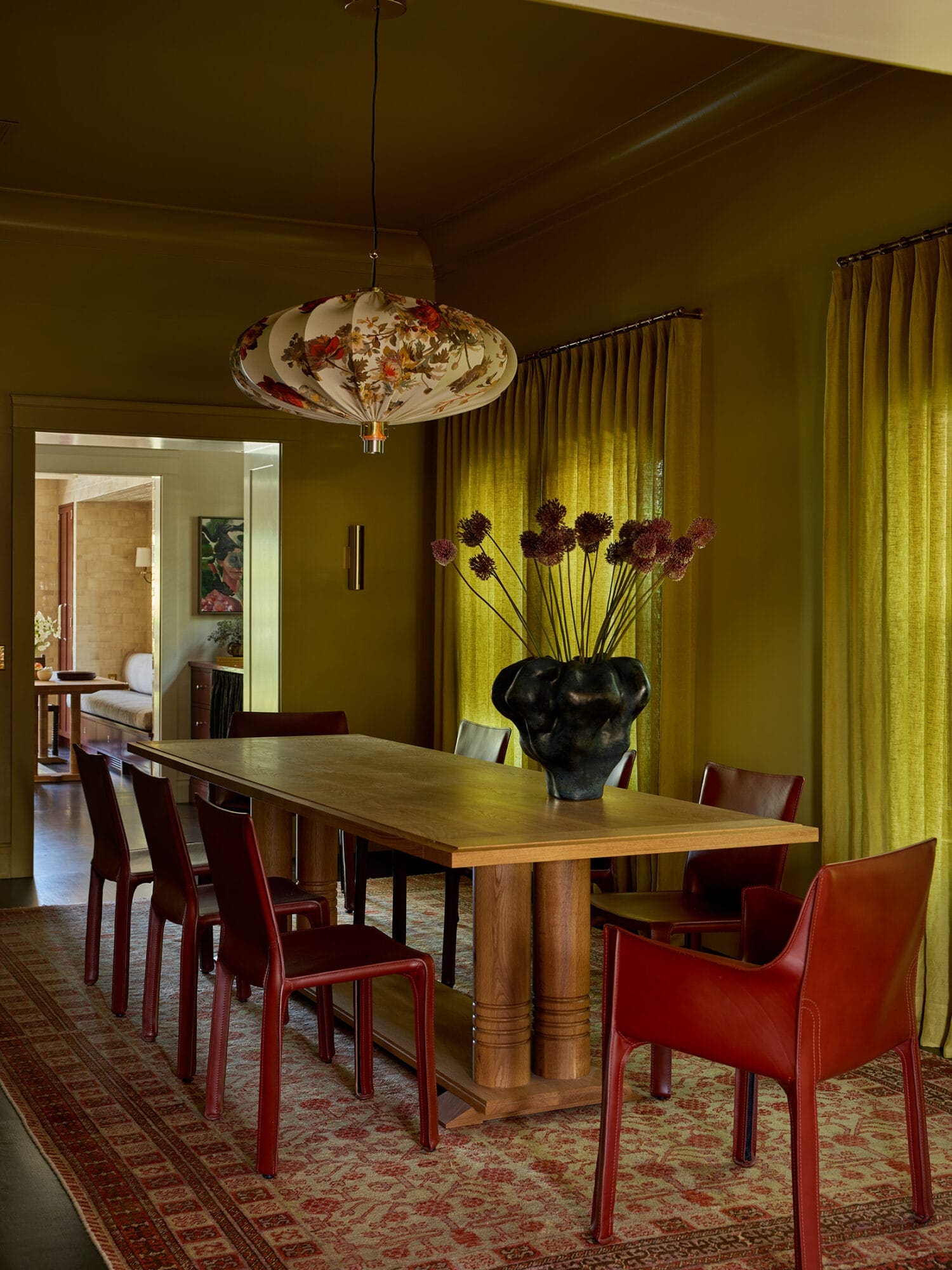 Oilive oil yellow dining room with red chairs
