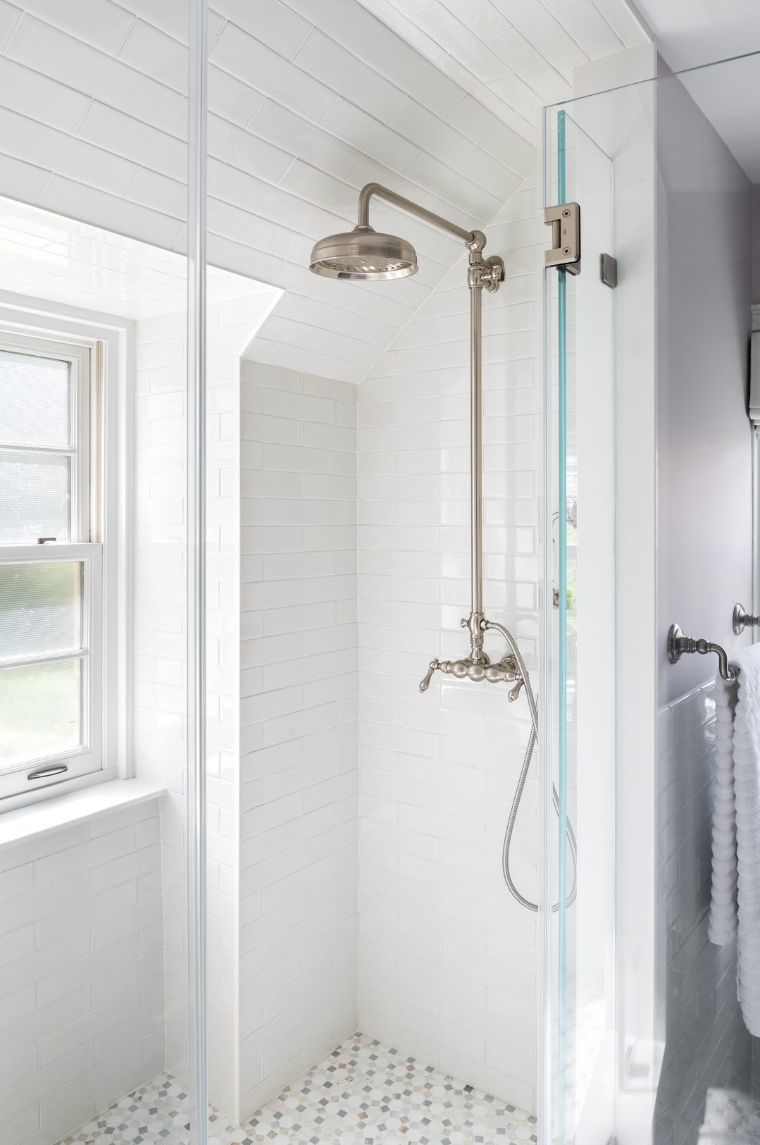 White shower tile with silver hardware