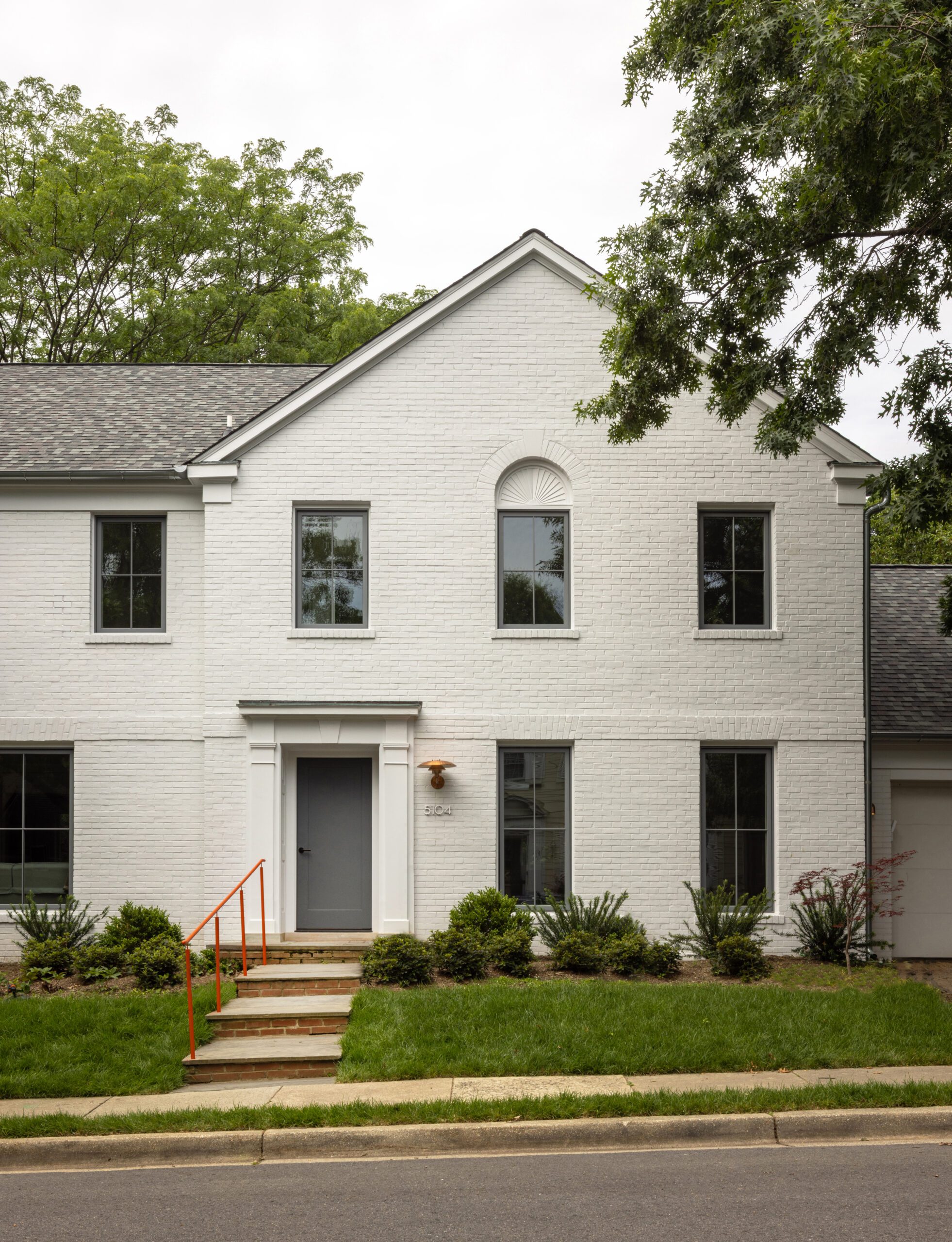 White facade exterior home with pop of color