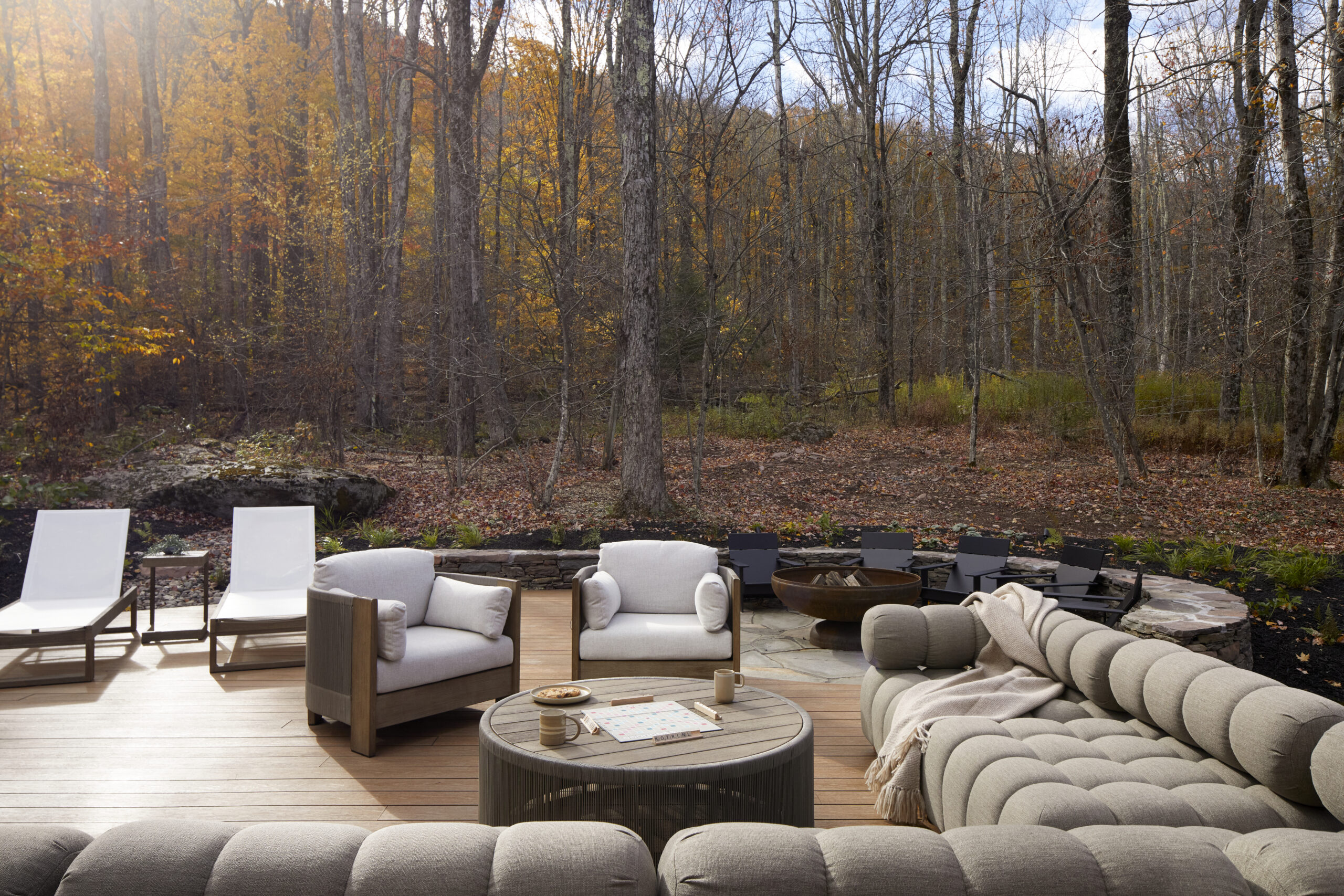Exterior A-frame cabin with dining table and lounge chairs
