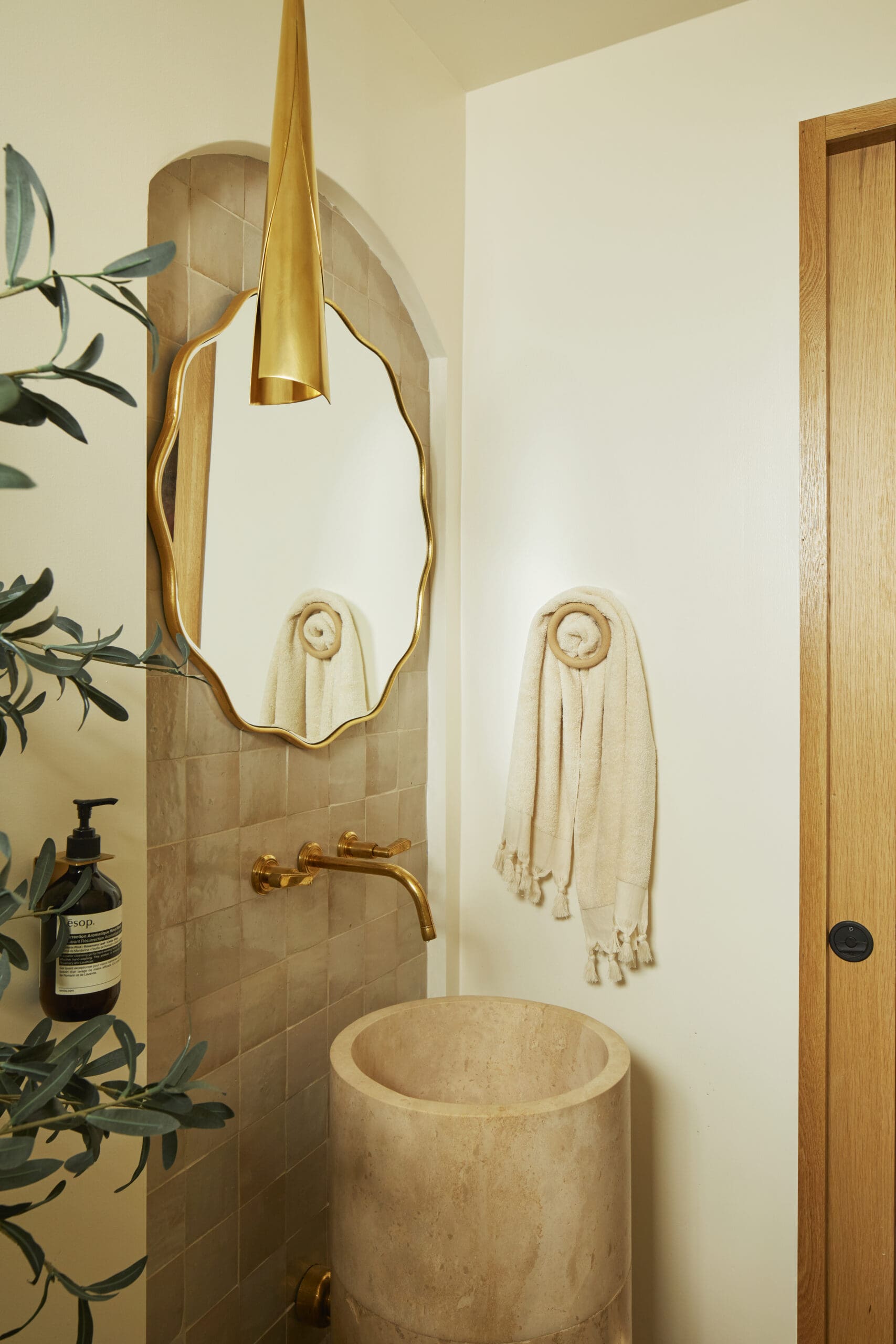 Powder bathroom with wavy mirror