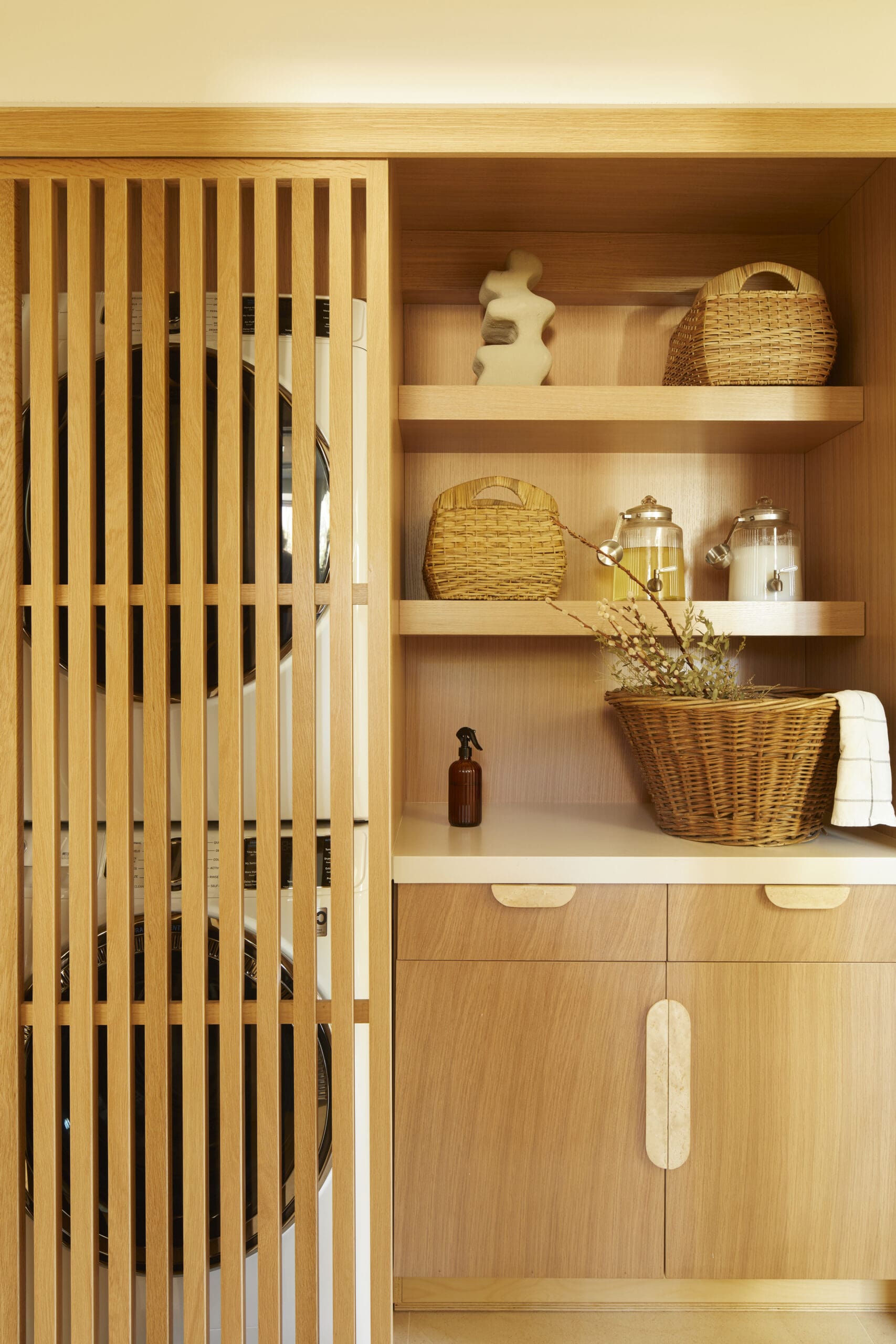 Laundry room with wooden cabinets