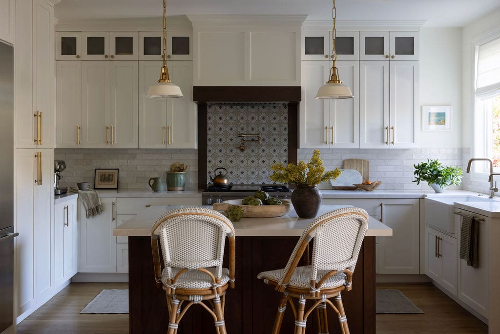 Open kitchen with walnut kitchen island and two chairs