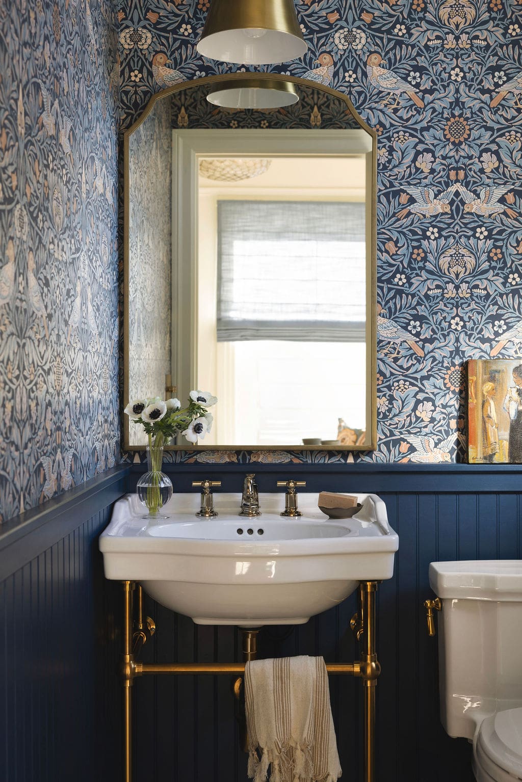 Bathroom with blue wallpaper and pedestal sink