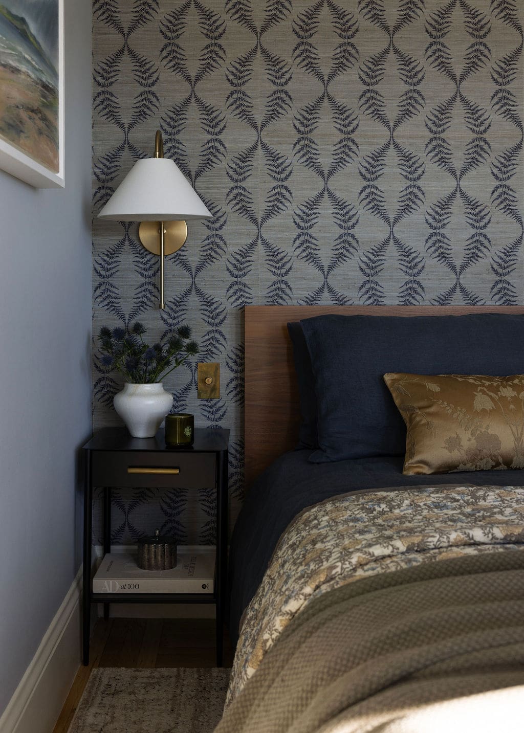 Bed frame and nightstands with wall sconce on wall