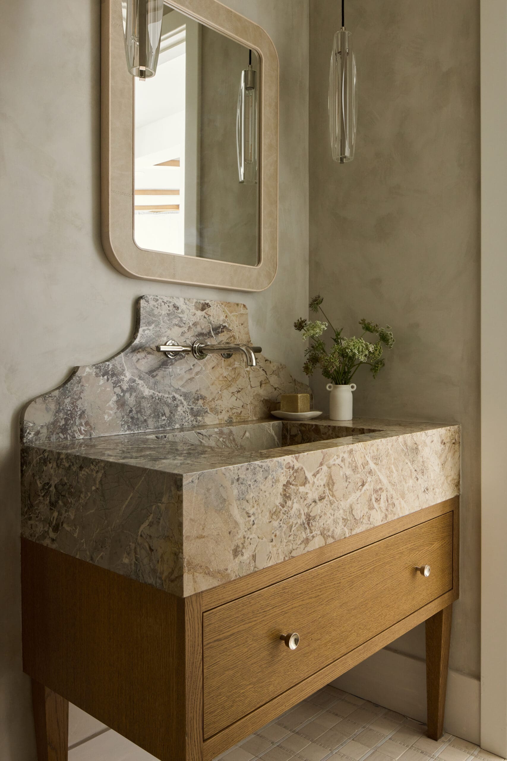 Marble bathroom sink and oak vanity