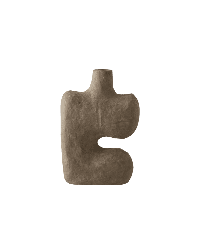 Brown textured ceramic sculpture shaped like a lowercase 'e' against a green background.