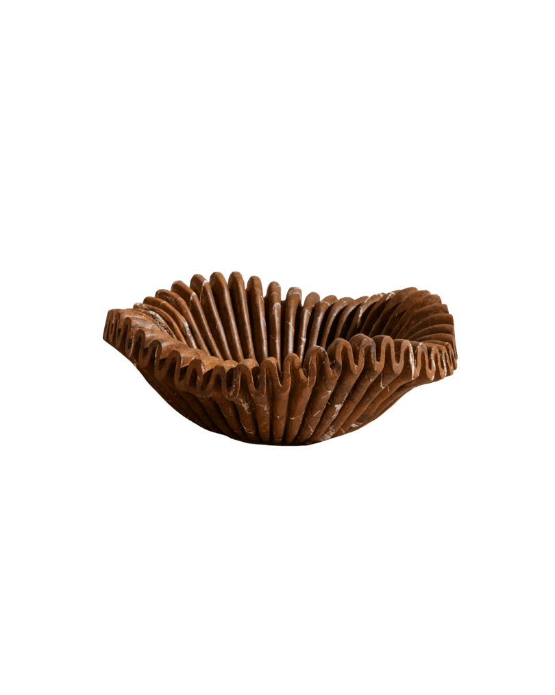 Ruffled milk chocolate cup with pleated edges on a black background