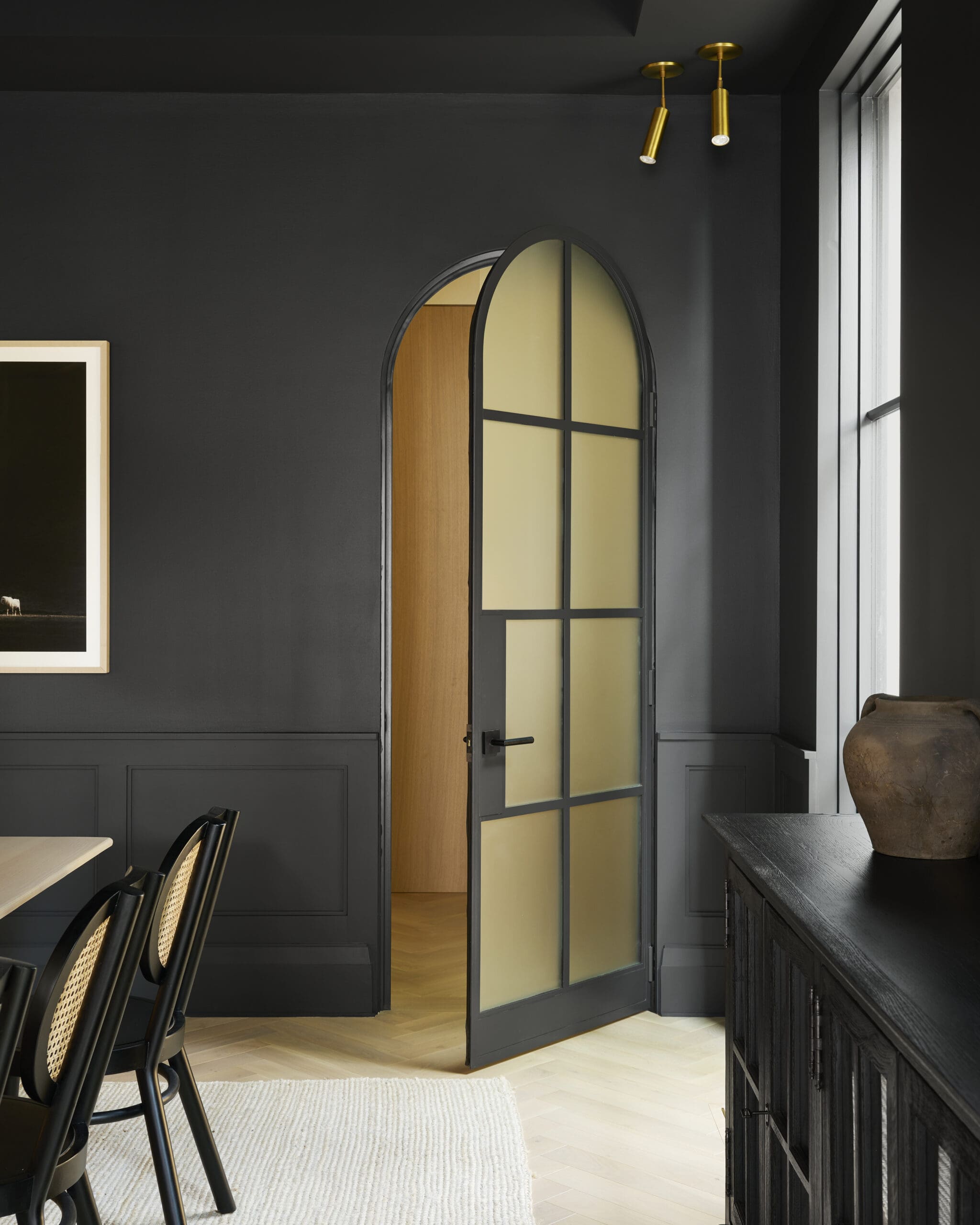 Black painted walls with arched door