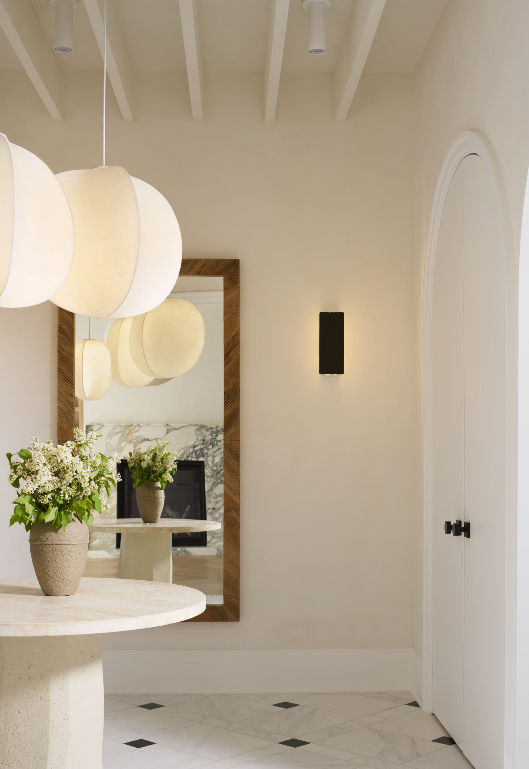 White entryway with mirror