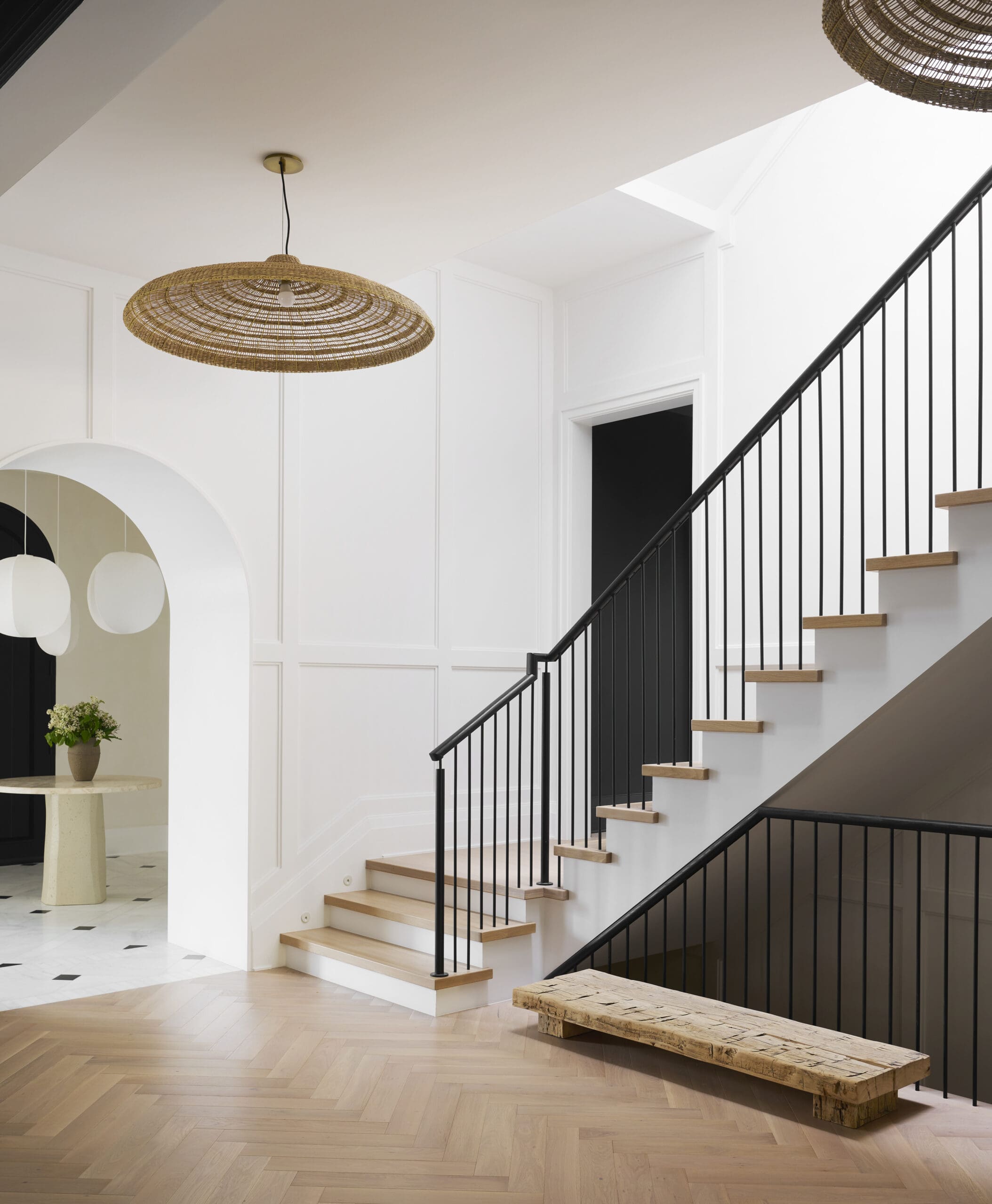 Entryway with white walls and sculptural pendant light