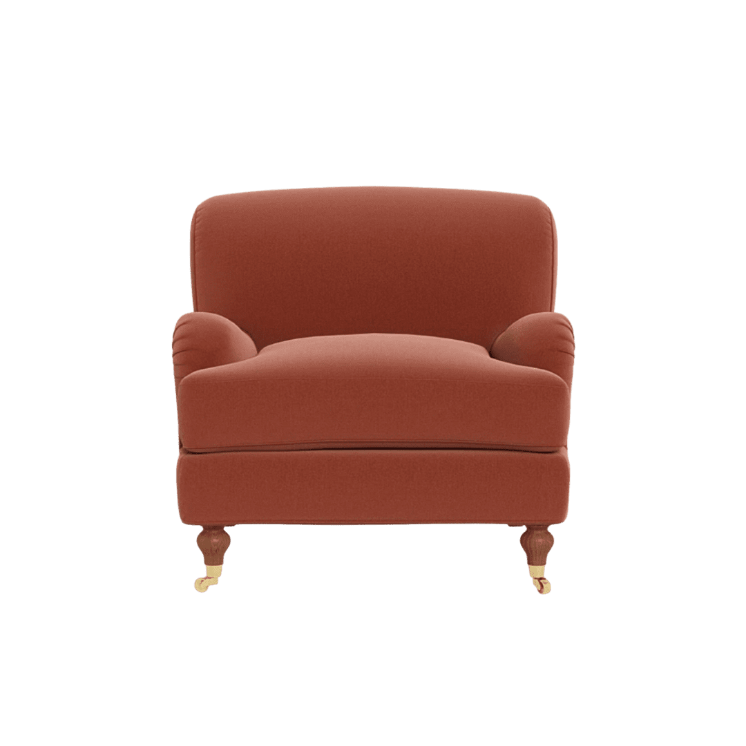 Red upholstered armchair with rounded arms and short wooden legs on casters.
