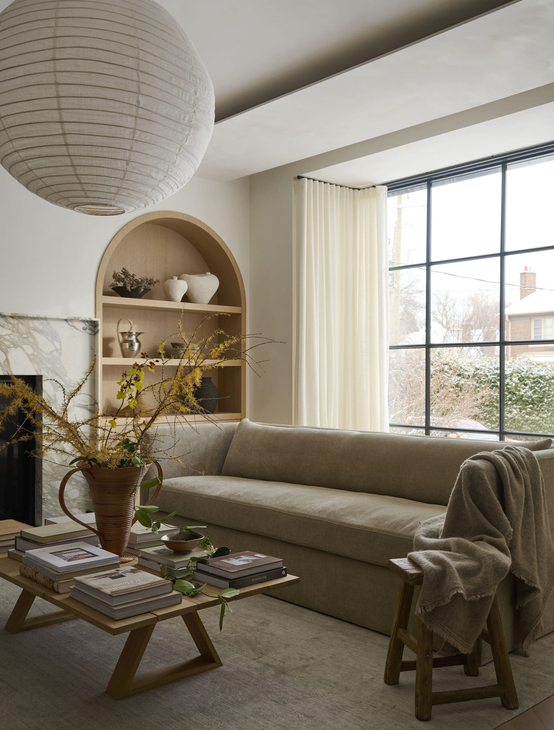 Living room with arched bookshelves