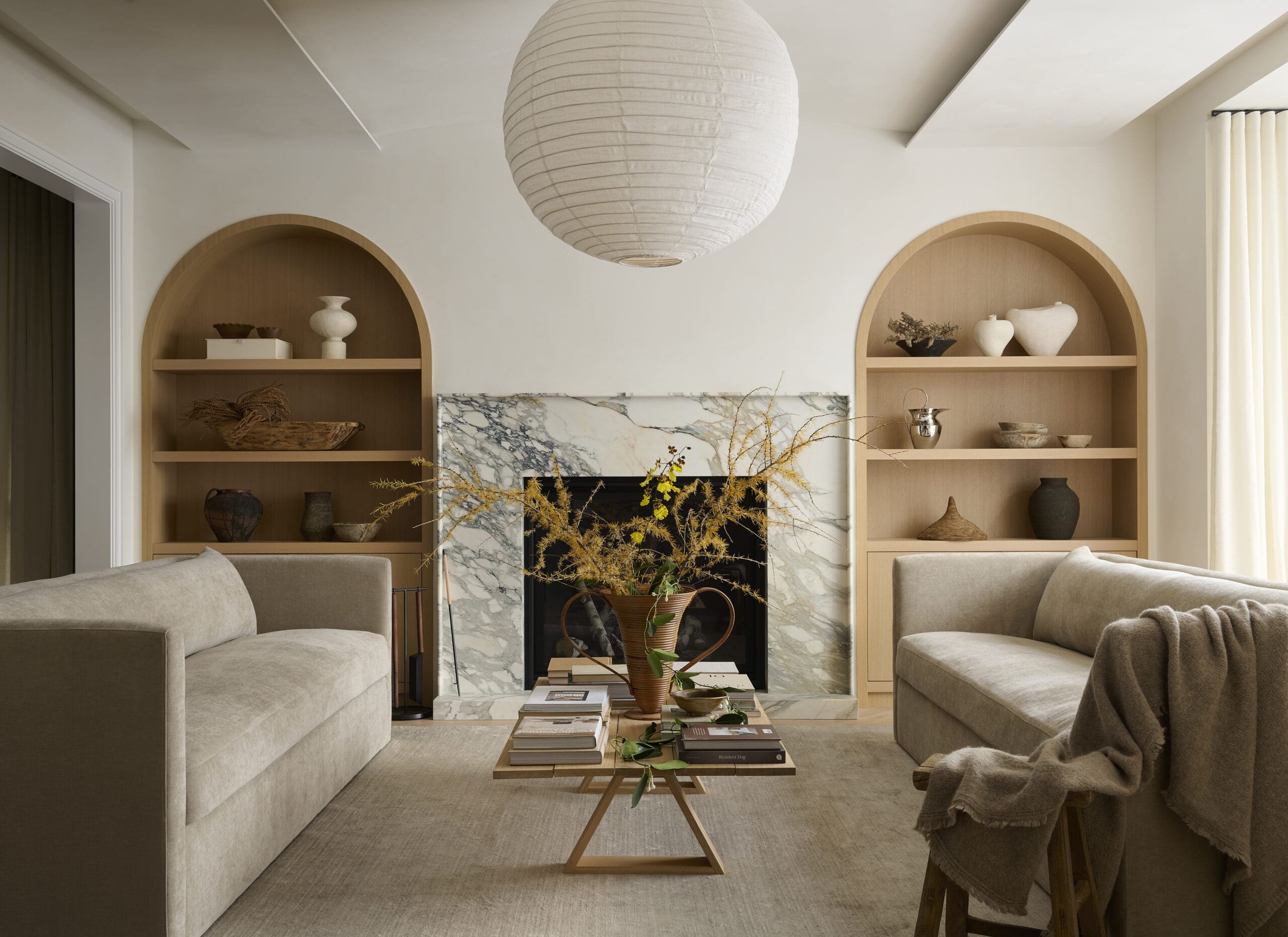 Living room with arched bookcases and two sofas